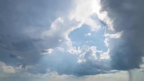 Fluffy White Clouds Moving in a Blue Sky