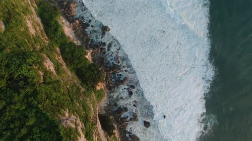 Aerial View of Rocky Coast with Big Waves at Sunset