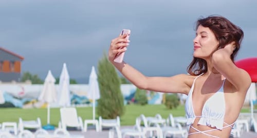 Pleasant Woman in Swimwear Taking Selfie on Smartphone
