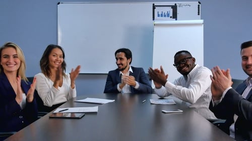 Group of Business People Applauding at Meeting