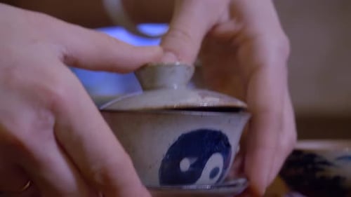 Woman Prepares Tea with Yin Yang Bowl