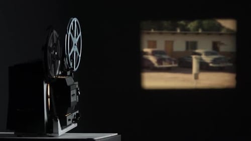 Film projected onto wall playing old film