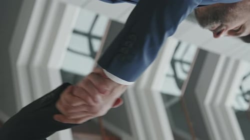 Vertical Close-Up of Businessmen Shaking Hands