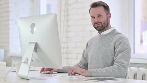Man Working on Computer in Modern Office