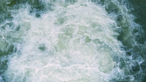 Mountain River with Clear Turquoise Water Falling Down in Cascades Between Wet Boulders with Thick