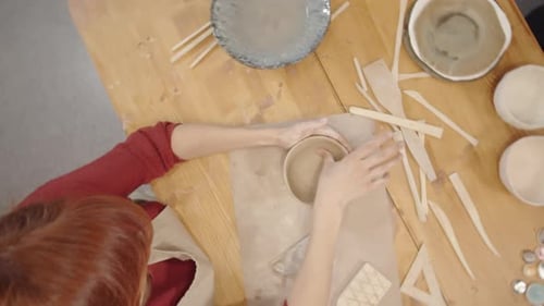 Woman Shaping Clay Bowl at Pottery Studio