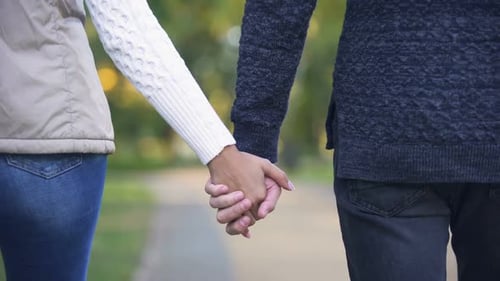 Back View of Couple Holding Hands and Confidently Walking in Bright Future