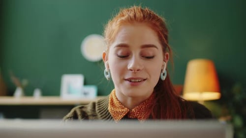 Cheerful Woman Talking on Video Call on Laptop in Office