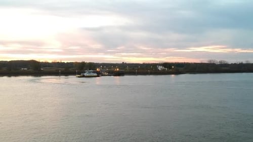 Small ferry boat is docking on other side of river for people transportation