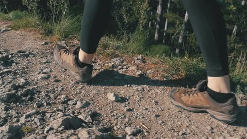 View on Feet of Traveler Woman Hiking Walking on the Top of Cliff in Mountain. Slow Motion
