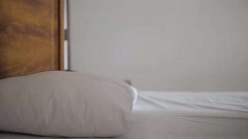 Woman Lying in Bed Relaxing Indoors