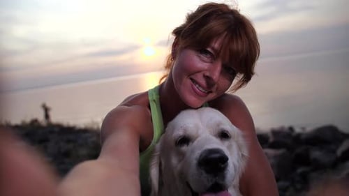 Smiling Woman Taking Selfie with Dog Pet Outdoors