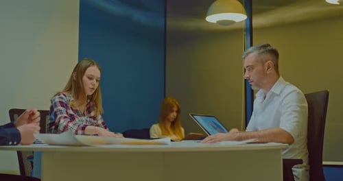 Beautiful Girl at a Meeting with Business Colleagues in a Modern Coworking Office
