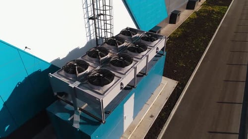 Set of Powerful Air Conditioners on Roof of Warehouse