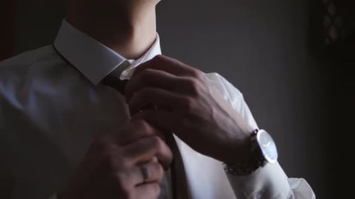 Man Adjusting Tie Before Wedding Day