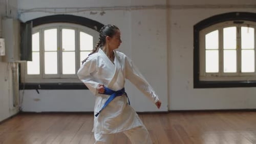 Front View of Martial Artsist Punching and Turning to Side