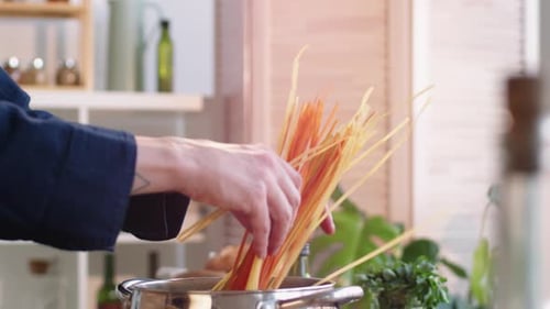 Putting Spaghetti into Pot with Boiling Water