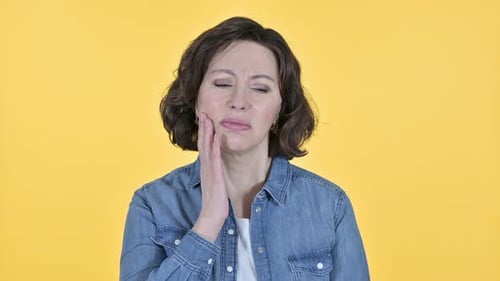 Old Woman with Toothache on Yellow Background