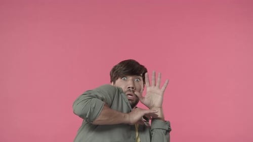 Adult Reacts in Surprise, Holding Hands Up