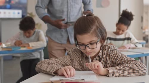 School Boy Doing Test in Classroom