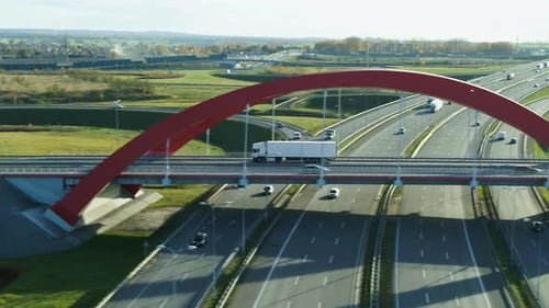 White Cargo Truck Crossing Highway Overpass - Aerial