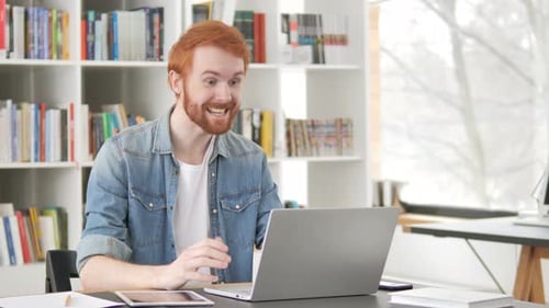 Man Video Calling on Laptop in Bright Office