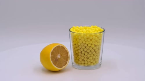 Lemon and Glass of Yellow Spheres