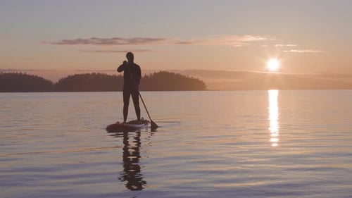 Adventurous Caucasian Adult Woman on a Stand Up Paddle Board