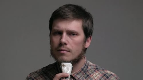 Young Adult Man Trimming His Beard