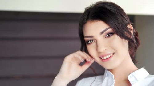 Elegant Brunette Woman Smiling Confidently at the Camera