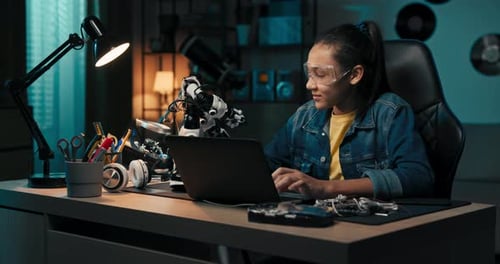 Girl Fascinated By Electronics Watches Robot Plays with Toy