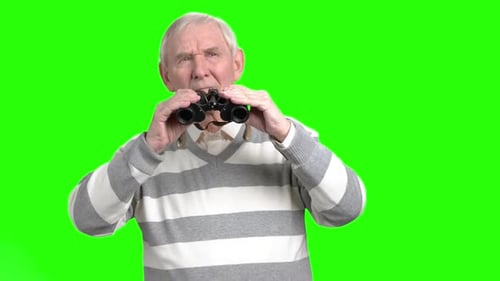 Senior Man Looking Through Binoculars on Green Screen