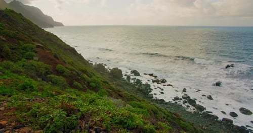 Colorful Sea Beach Waves Foaming and Splashing on the Rocky Shoreline