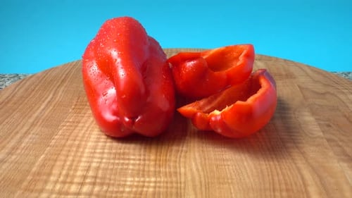Fresh Red Bell Pepper Slices on Wooden Board