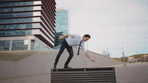 Flexible and cool businessman doing acrobatic tricks outdoor.
