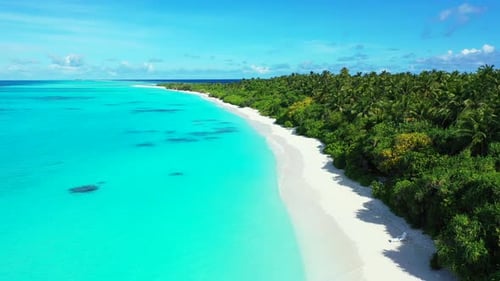 Daytime overhead travel shot of a sandy white paradise beach and aqua blue ocean background in hi re