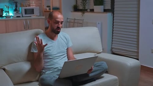 Man Video Calling on Laptop at Home