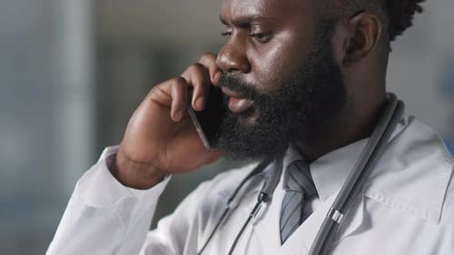 Doctor in Lab Coat Talking on Phone
