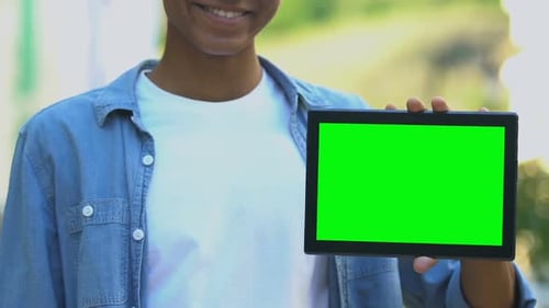 Person Pointing to Tablet with Green Screen