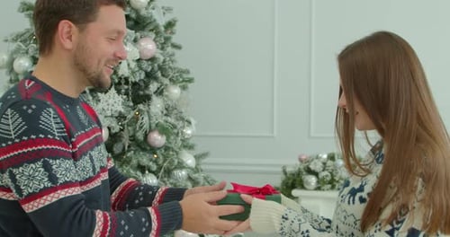 Pretty Girl Hugging with Boyfriend at Christmas Celebrating Holidays Together. Close Up of Young