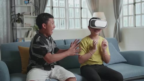 Young Adults Enjoying a Virtual Reality Experience at Home