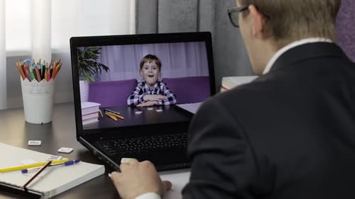 Child and Adult Video Call on Laptop