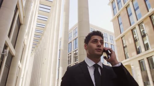 Young Adult Businessman Talking on Smartphone Outdoors