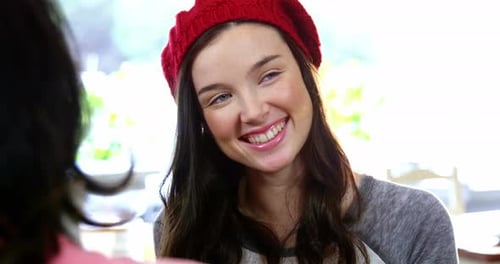 Smiling Young Adult Woman in Red Knit Cap