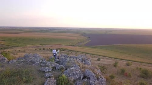 Girl artist paints a picture with oil paints. Aerial view