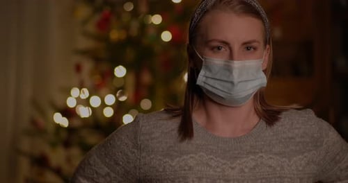 Woman Wearing Protective Mask During Christmas at Home