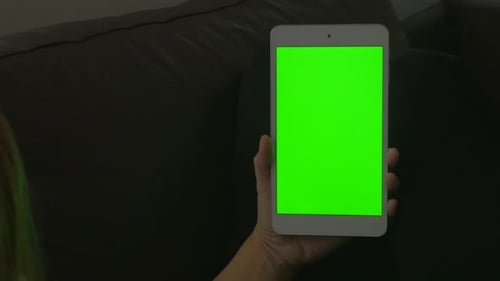 Woman holding tablet PC with green screen display 4K 3840X2160 UltraHD pan video - Female with Table