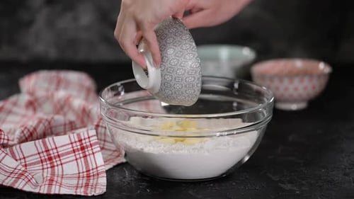 Preparing Dough with Butter in a Glass Bowl