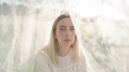 Woman Surrounded by White Fabric in Natural Light