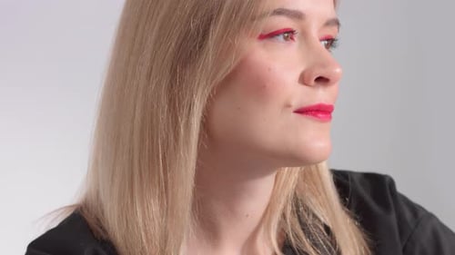 Blonde Woman with Bright Red Makeup in Studio